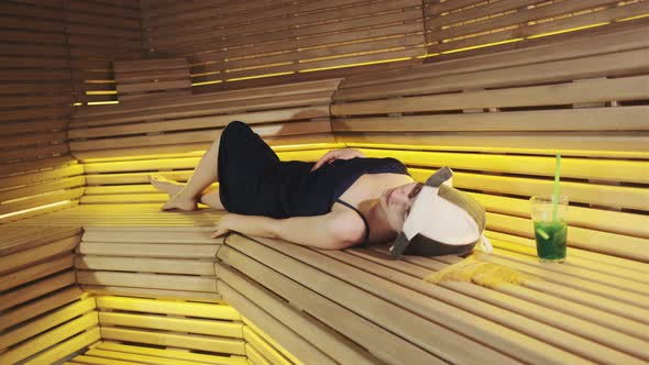 Young Woman Having a Rest in Sauna