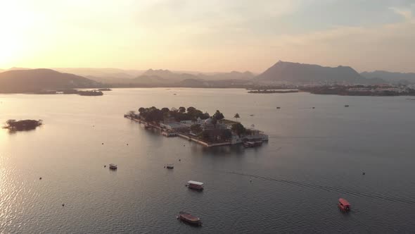 Drone footage of the Taj Lake Palace on Lake Pichola during sunset near the city of Udaipur, India