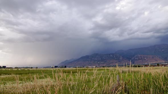 Lightning striking as storm moves over mountains in timelapse