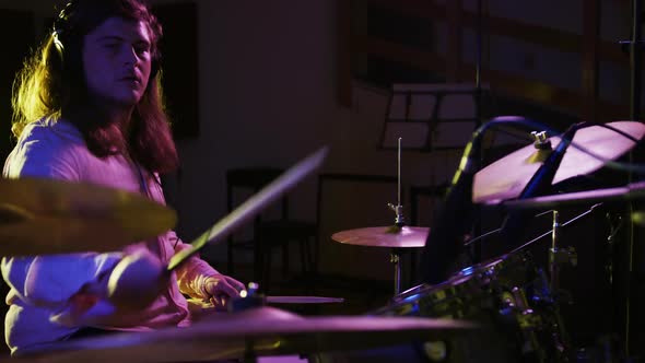 Man playing drums in a music studio