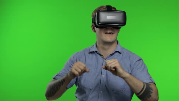 Man Using VR App Helmet To Play Simulation Game, Drawing. Guy Watching Virtual Reality 3d Video