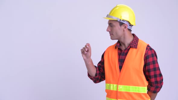 Young Happy Hispanic Man Construction Worker Touching Something