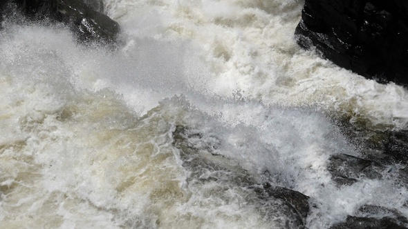 Strong flow and boiling of water in mountain river with