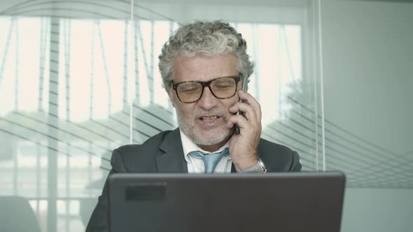 Confident Mature Business Professional Wearing Suit and Glasses