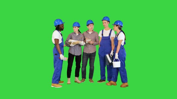 Teamwork and People Concept Group Construction Workers Have a Talk on a Green Screen Chroma Key