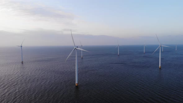 Offshore Windmill Park with Clouds and a Blue Sky Windmill Park in the Ocean Drone Aerial View with