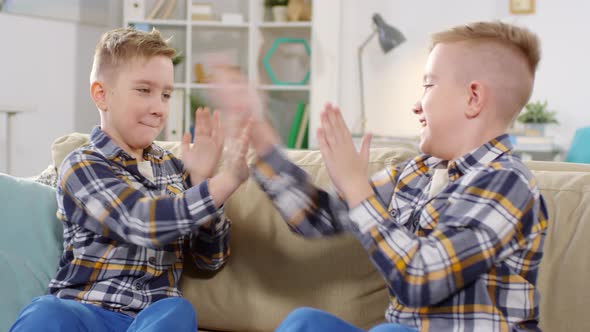 Twin Brothers Playing Clapping Game at Home