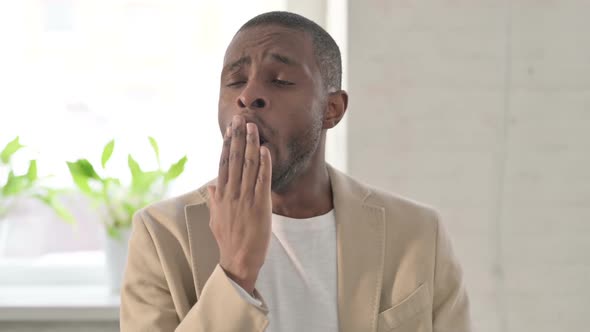 Portrait of Sleepy African Man Yawning