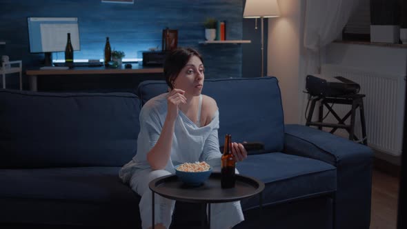 Bored Woman Switching TV Channels Holding Remote Controller Eating Popcorn