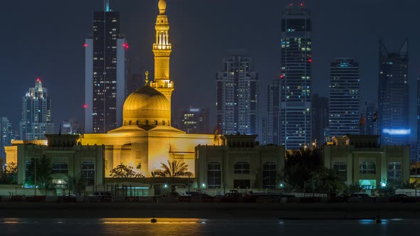 Modern Dubai City Skyline Timelapse with Rashid Al Hadeeth Mosque at Night with Illuminated