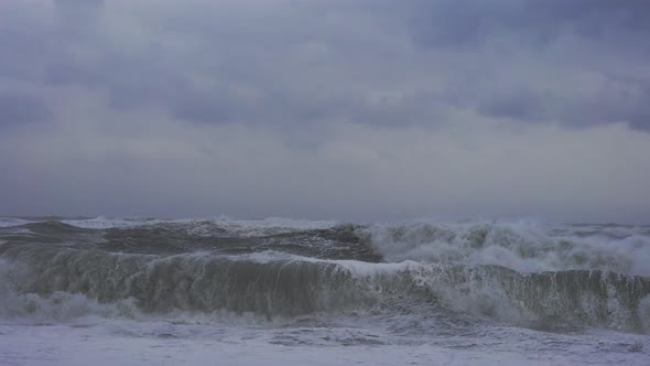 Rough And Stormy Sea Crashing Onto Black Sand Beach