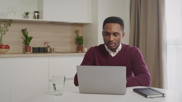 Excited Africanamerican Guy Receiving Good News on Laptop