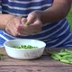 Girl Finger Hulled Fresh Peas in Plate Wooden Table Outdoor - VideoHive Item for Sale