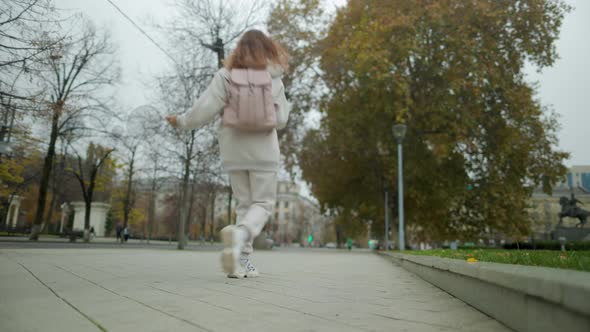 Beautiful Woman In Headphones Dancing On City Street