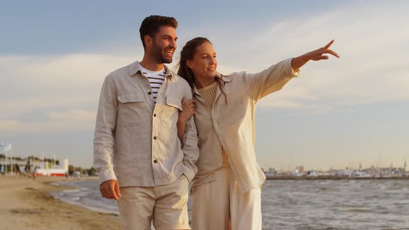 Happy Couple Walking Along Summer Beach