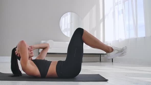 Young Girl Doing Bicycle Crunches Exercise Working Out at Home