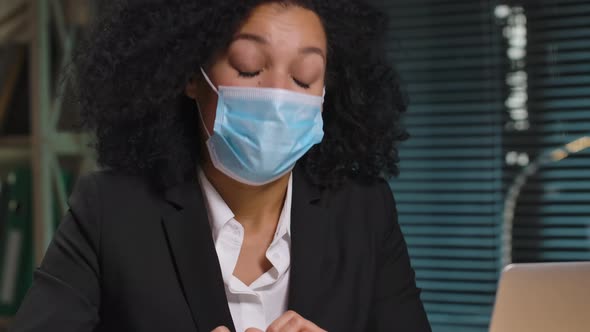 Portrait of African American Woman in Medical Mask Talking on Video Conference on Laptop