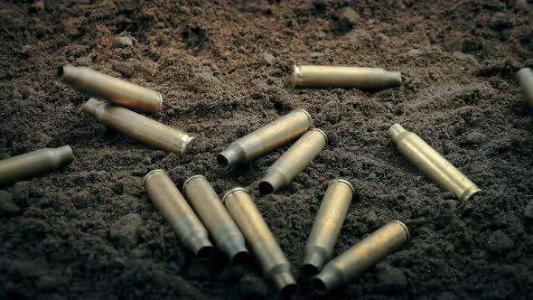 Bullet Casings Drop To The Ground As Rifle Is Fired