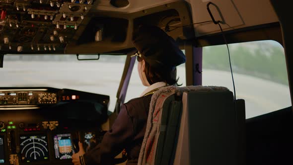 Portrait of Woman Copilot Flying Airplane with Captain in Cockpit