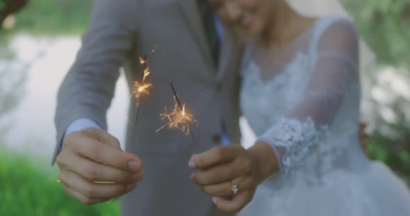 Happy Asian Bride And Groom In Wedding Dress Burning Sparklers Bengal Lights