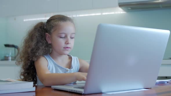 Little Girl a Cute Elementary School Child of 7-8 Years Old at Home Studying in Family Learning