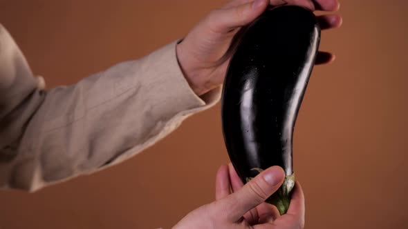 Man Holding an Eggplant Aubergine Closeup