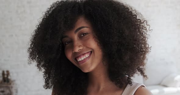 Happy Joyful Young Black Lady with Curly Hair Delighted at Good News or Birthday Celebration