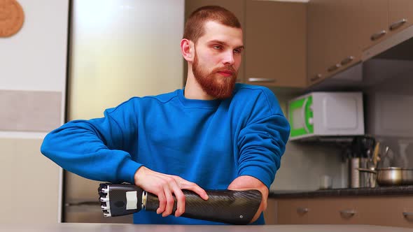 Young Man with Modern Biotechnology Hand in Apartment