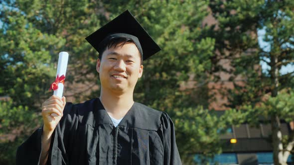 Portrait of a Happy Graduate Student in Mantle and Cap