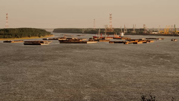 Timelapse with stationary barges at the sunset on Danube river