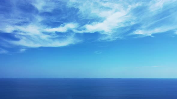 Wide angle fly over clean view of a white sand paradise beach and blue ocean background in hi res 4K