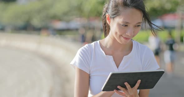 Woman Drawing on Tablet Computer Under Sunset