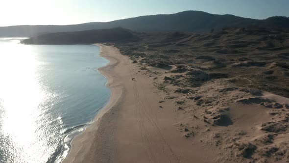 Video over beautiful wild beach with sand dunes and clear sea waters