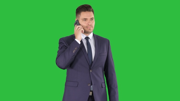 Thoughtful Young Businessman in Suit and Tie Making Several