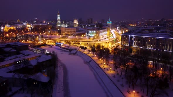 Evening illuminated Kharkiv city river aerial view