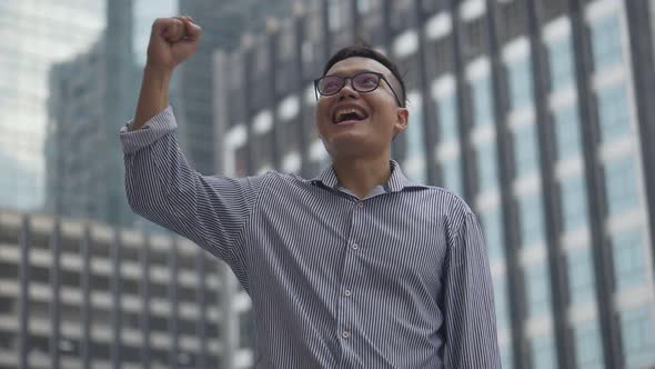 Portrait handsome Asian businessman after a working have success and achievement.