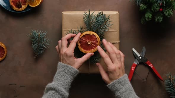 Female Hands Decorates Christmas Gift Box