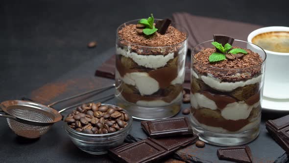 Classic Tiramisu Dessert in a Glass and Cup of Coffee on Dark Concrete Background