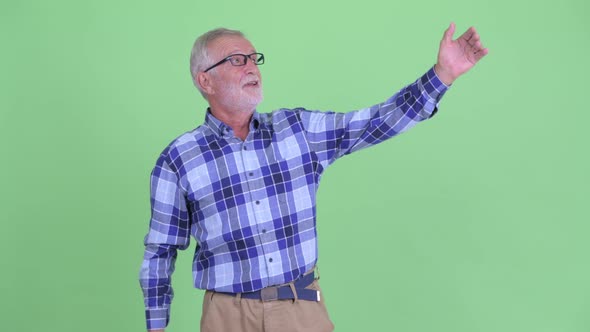 Happy Senior Bearded Hipster Man Looking Around and Feeling Excited