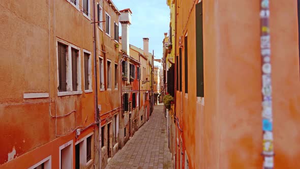 Deserted Cobblestone Sidewalk Between Terracotta Buildings