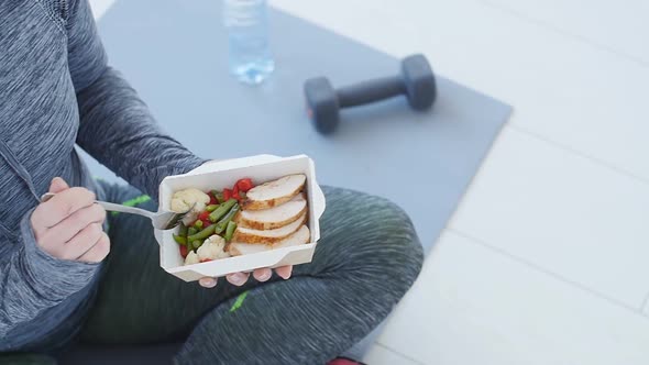 Fitness and Healthy Food. Woman Is Resting and Eating a Healthy Food After a Workout