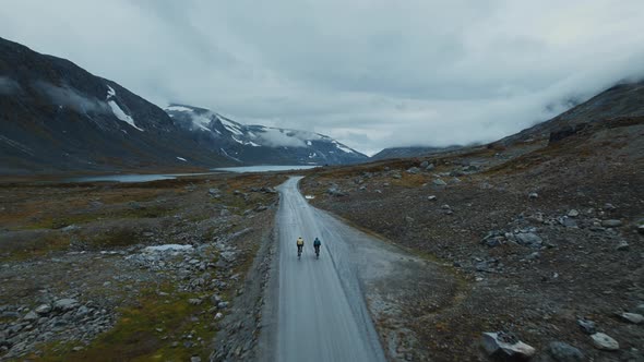 Aerial Flying Drone Shot of Young Cyclists Riding