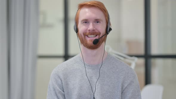 Portrait of Smiling Redhead Man Wearing Headset with Mic 