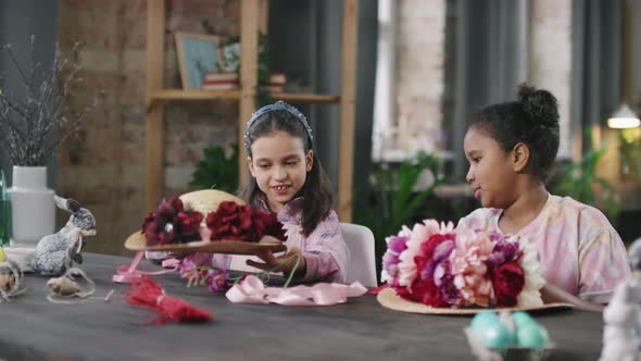 Little Girls Decorating Sun Hats with Flowers