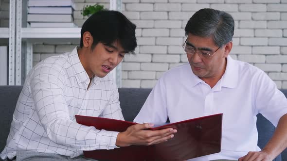 Senior man talking with insurance agent at home. Financial advisor consulting with senior man.