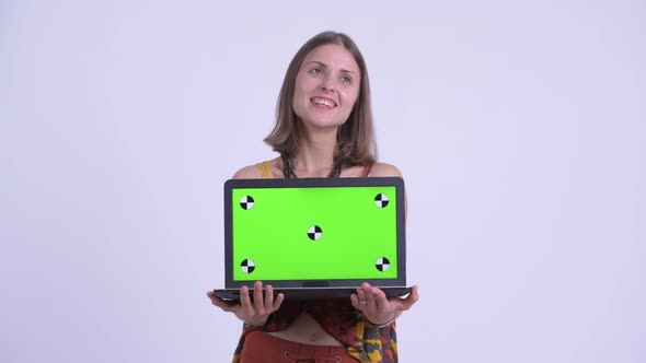 Young Happy Hipster Woman Thinking While Showing Laptop