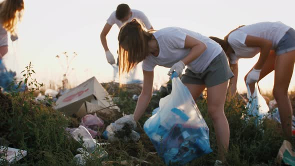 Group of Eco Volunteers Cleaning Up Area of Dump Near the Field