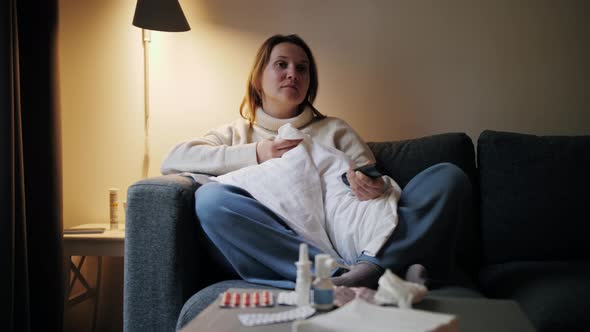 Ill Woman at Home Sitting on Sofa Sneezing Watching Tv Female Having Runny Nose