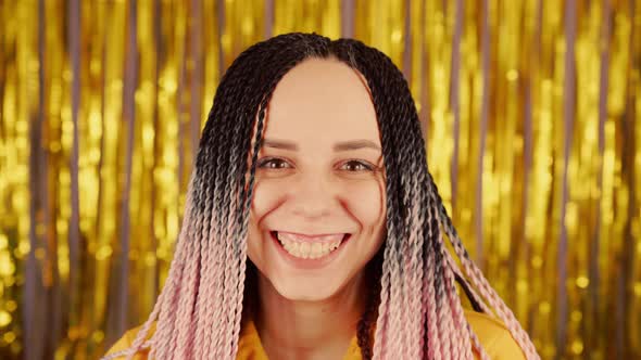 Young Woman with Senegalese Pigtails Looking at Camera