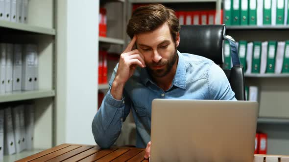 Executive using laptop at desk